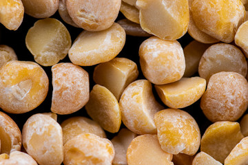 halves of dried crushed pea seeds on a black background