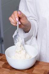 part of the girl is preparing breakfast
close-up, milk porridge,