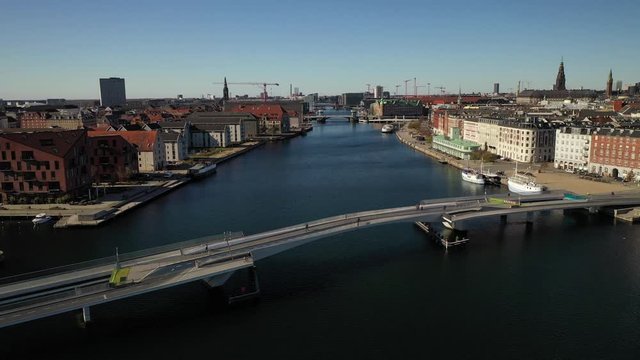 Dreamy dolly into a picturesque and quant European capital city with pedestrian and car traffic taking advantage of the beautiful day