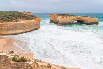 Rock formations with ocean sea waves on coastline. London Arch gorge on Great Ocean Road,...