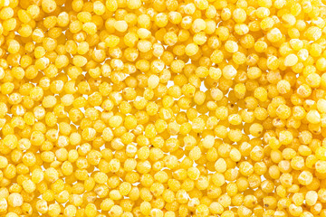 millet round yellow seeds on a white background