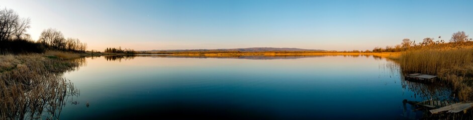 colorful panorama of autumn lake on a bright sunny day