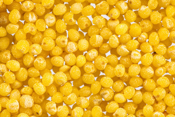 millet round yellow seeds on a white background