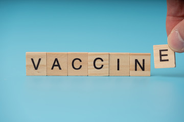 Vaccine infection concept. Letter  of  wooden blocks
