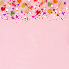 Top view decoration assorted gummy candies and jelly sweets happy holiday background concept. Flat lay colorful candy on beautiful pink desk. Copy space.