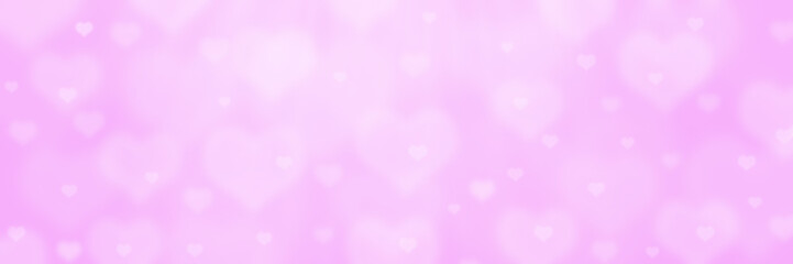 Abstract pink bokeh banner background with hearts - birthday, father's day, valentine's day panorama - blurry bokeh circles and hearts on a pink background.
