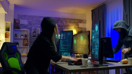 Police lights while team of hackers are running away