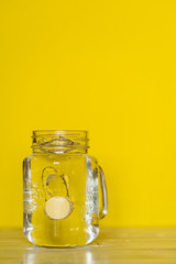 A tablet and a glass of water. Vitamin C
