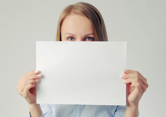 pretty girl with empty paper sheet. Poster with copy-space concept