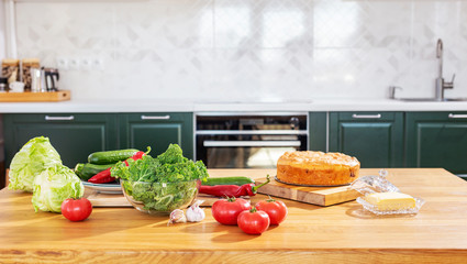 Fresh vegetables on the table. Kale cabbage, tomatoes, zucchini, cucumbers, paprika, white cabbage.