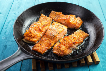 Pan seared salmon fillets on cast iron skillet - 338006886