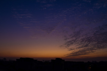 sunset over the city with beautiful cloud formations  