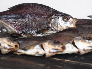 Privately dried, in the air, salty freshwater bream on a dark wooden background.