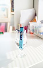 TDS meter in glass to determine quality of  water.