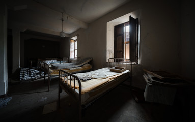 Dark and scary bedroom of an abandoned house