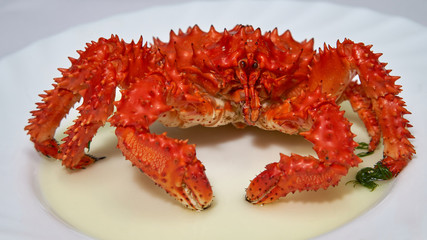 Kamchatka red king crab is boiled in boiling water in a pan.