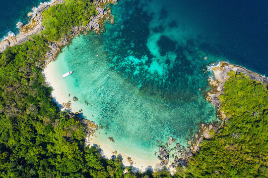 Aerial view drone shot ocean waves, Beautiful tropical beach and rocky coastline and beautiful forest. Nga Khin Nyo Gyee Island Myanmar. Tropical seas and islands in southern Myanmar