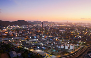 Aerial view oil storage tank with oil refinery factory industrial. Oil refinery plant at night. industry factory concept and transportation.