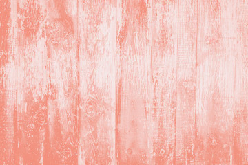 Old rustic wooden background  toned in trendy color 2020 coral pink.