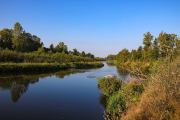 Fototapeta na wymiar Dawn on the bank of a winding river.