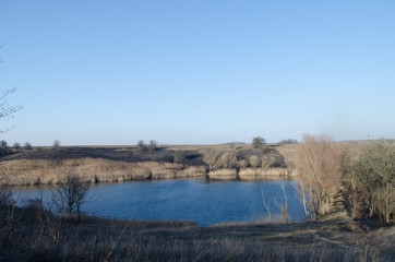 Gray landscape with a blue lake