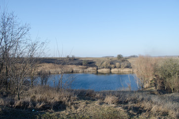 Gray landscape with a blue lake