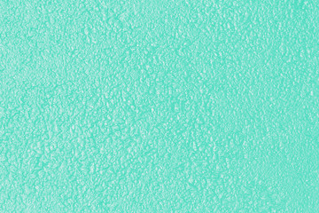 Fototapeta na wymiar Wet abstract background. Texture toned in trendy color of 2020 biscay green.