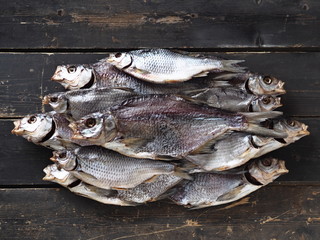 Air-dried,privately owned, freshwater river fish bream, on a dark wooden table.Close up.