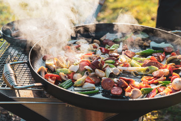 Cooking colorful food outdoors on a mobile fire pit