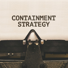Containment Strategy words on paper from vintage typewriter, corona virus pandemic buzwword headline