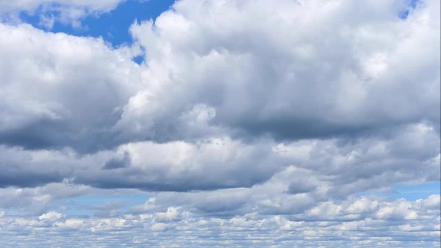 Aerial time lapse of white cumulus clouds flying in the blue sky. nice view on the sky from the top of the hill