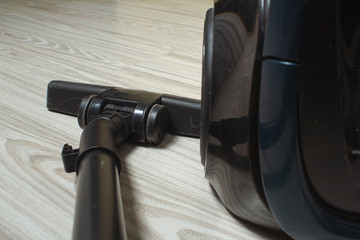 black vacuum cleaner on a light floor