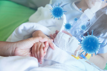 Fototapeta premium Closeup mother hand hold child patient with saline solution in hospital