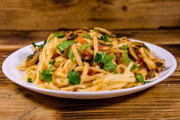 Pasta with mushrooms and tomato sauce in a plate