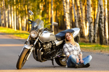 Fototapeta na wymiar Sexy girl near a classic motorcycle