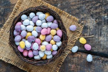 Colorful Easter chocolate eggs in a nest.