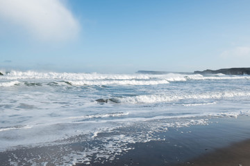 Waves crash on the beach on the North Antrim coast