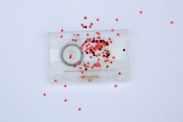 old film cassette with red sparkles on an isolated background close-up