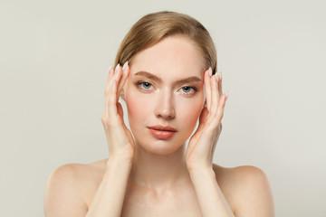 Young woman with clear skin. Skincare and facial treatment concept