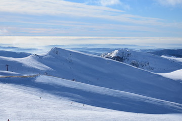 Clouds in snowy mountain tops in winter in Busteni Romania