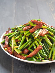Stir fried Garlic Shoots with pork. Chinese food.