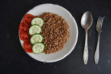 vegetarian food buckwheat with vegetables on the table
