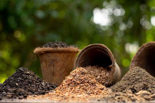 Soil, manure and sawdust are stacked in the middle of the green nature.