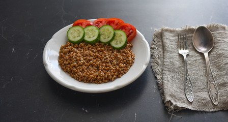 vegetarian food buckwheat with vegetables on the table