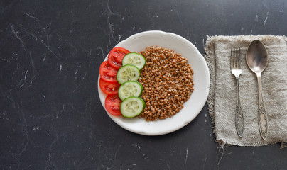 vegetarian food buckwheat with vegetables on the table