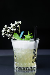 .refreshing alcoholic cocktail made of pineapple juice decorated with mint and flowers