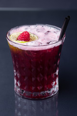 .red alcoholic cocktail with raspberries. raspberry lemonade