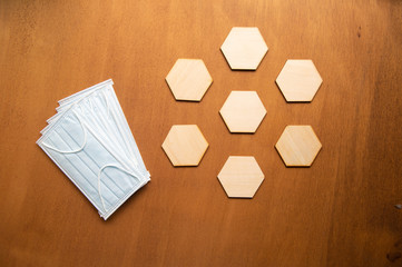 epidemic healthcare concept ,medical face mask and .Abstract hexagonal  on wooden table...
