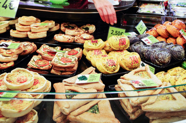 A shop with traditional pastries at the Boqueria market, Barcelona ​​Spain. Sale of pastries and tapas