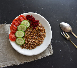 vegetarian food buckwheat with vegetables on the table